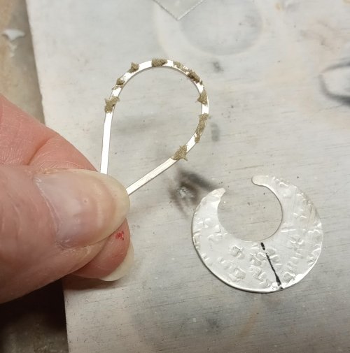 Judy Larson's Disc Cutter Earrings Remodel - , Metalwork, Cutting, Cutting Tool, Cutters, Filing, Finishing, Butane Torch, Soldering, Solder, Press the teardrop in place on the disc on a soldering surface